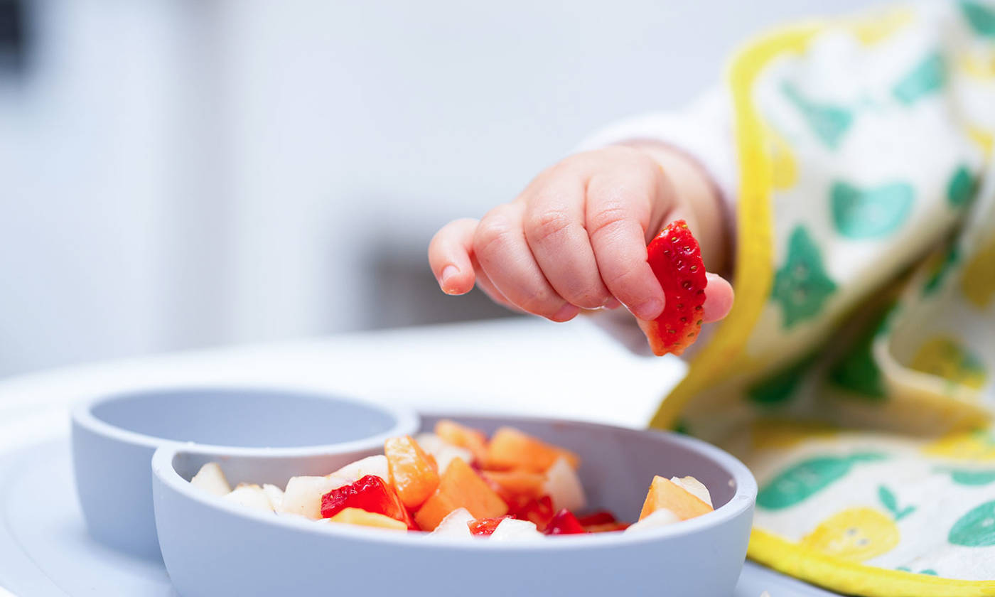 Toddler eating from a bowl