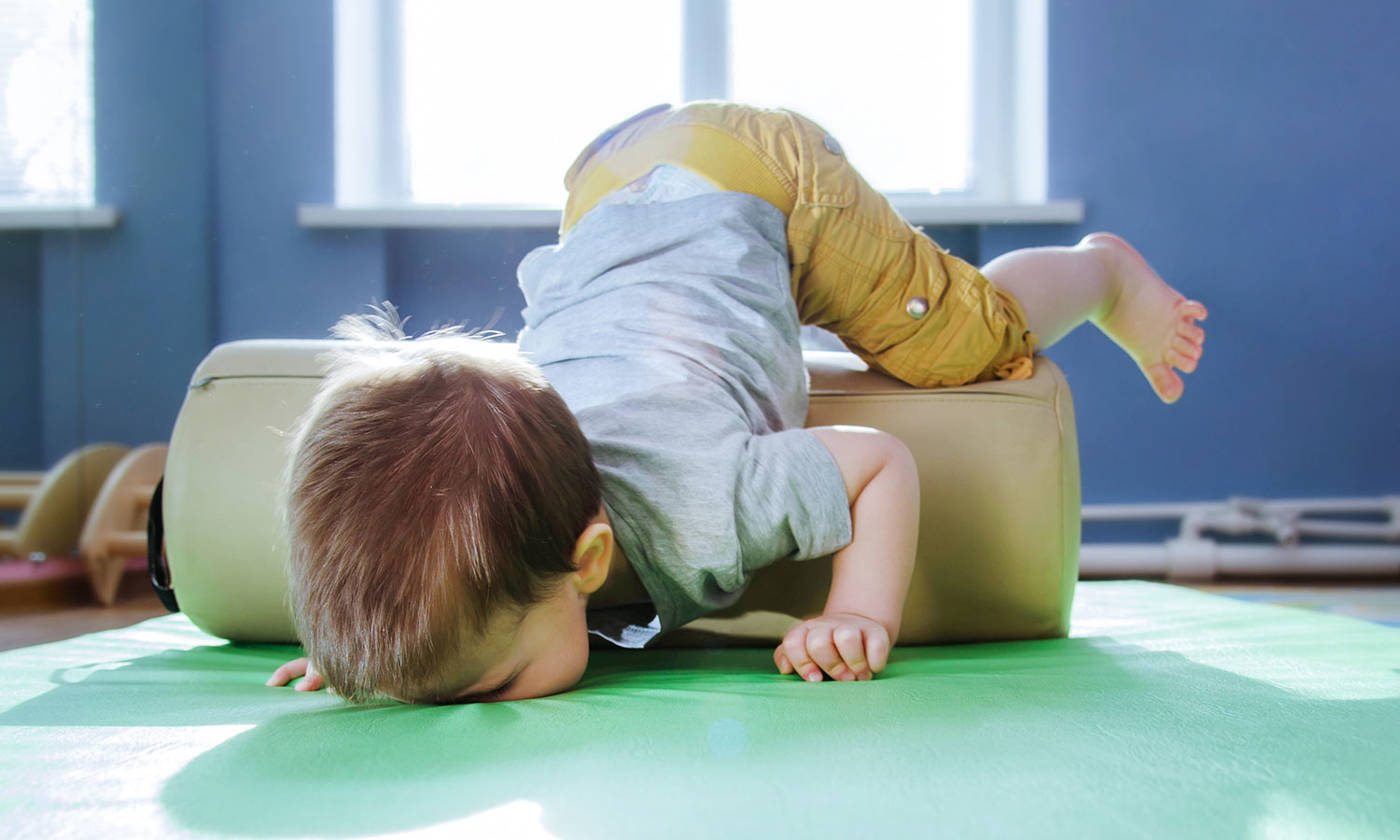 Child falling face down on a mat