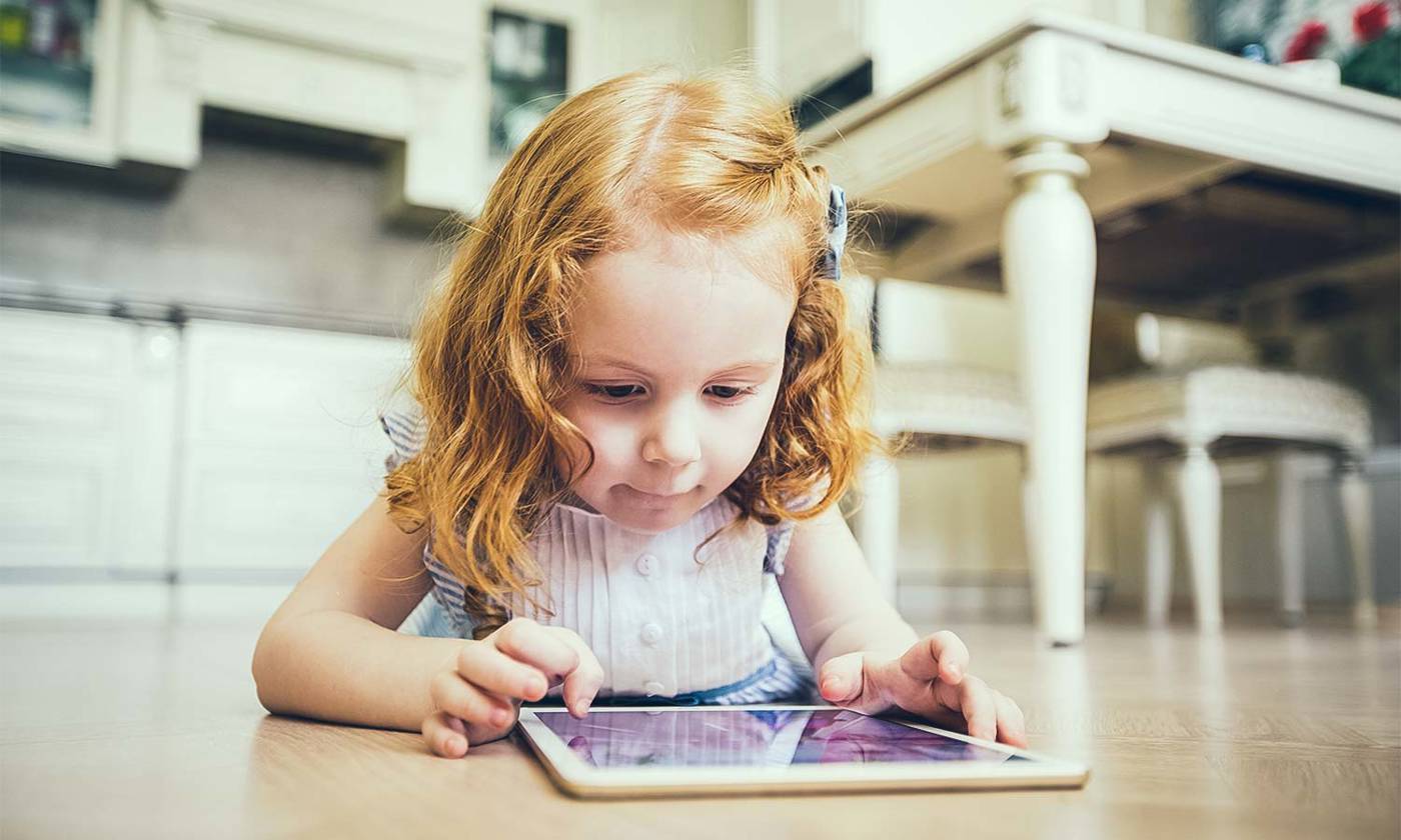 Young girl plays on an iPad