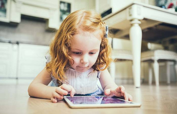 Young girl plays on an iPad