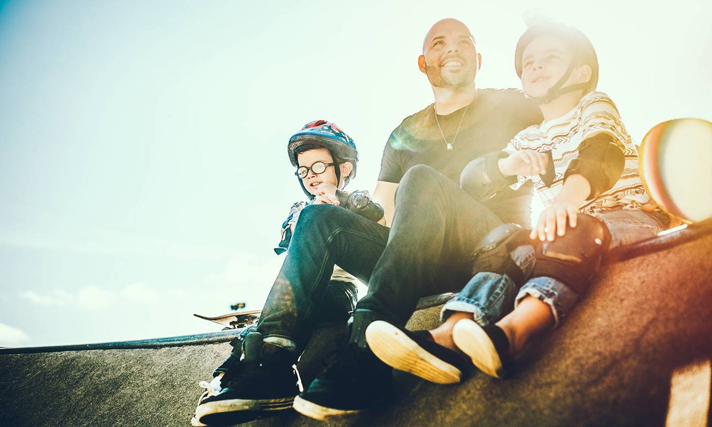 Father and sons skateboarding