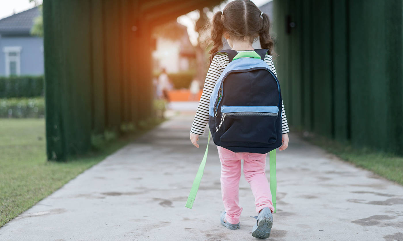 Little girl walking alone after learning
