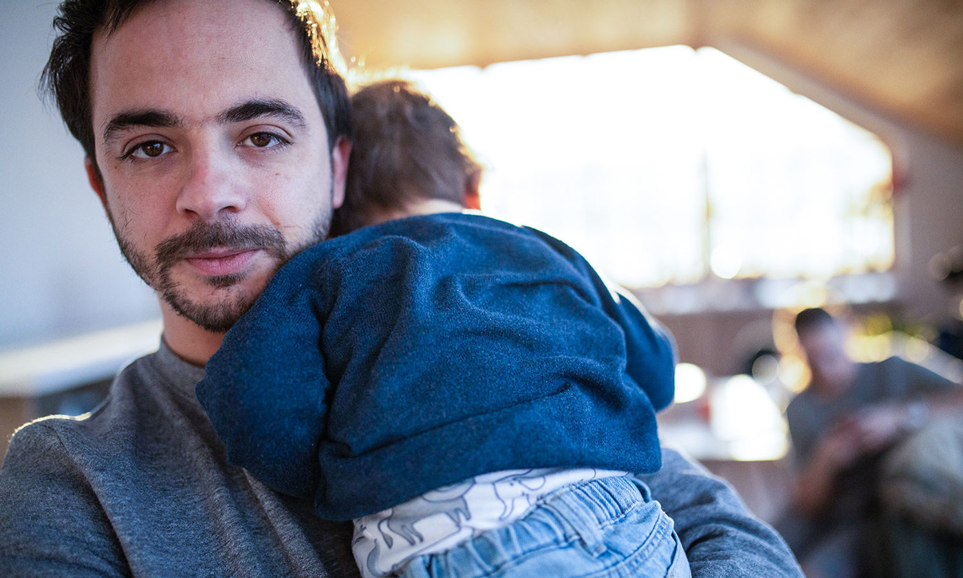 Adult man holding baby boy