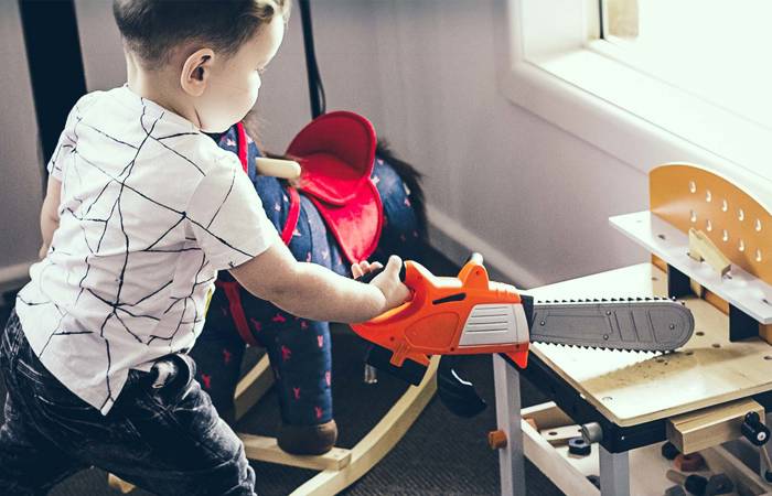 Boy with toy chainsaw