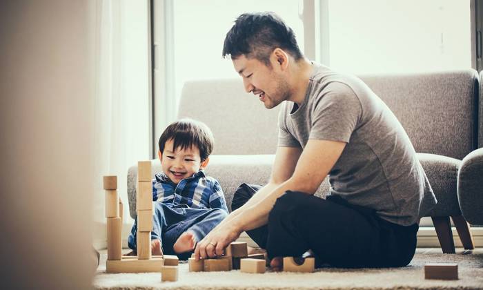 Father and son playing with building blocks together