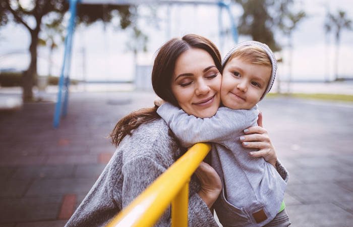 Mum gives a hug to her young son