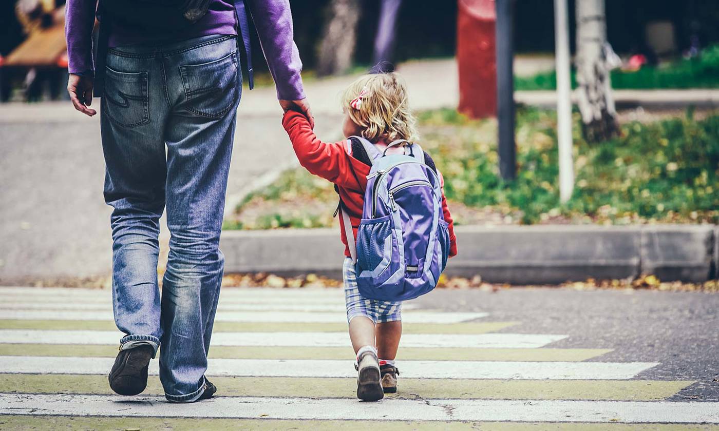 Parent walking child to kindergarten