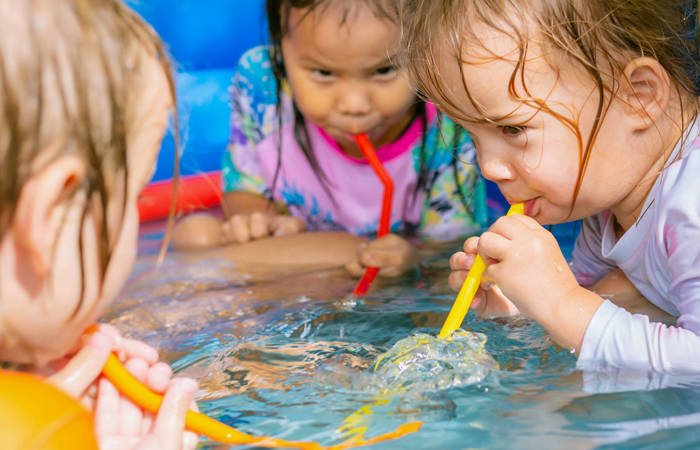 Three children playing with water