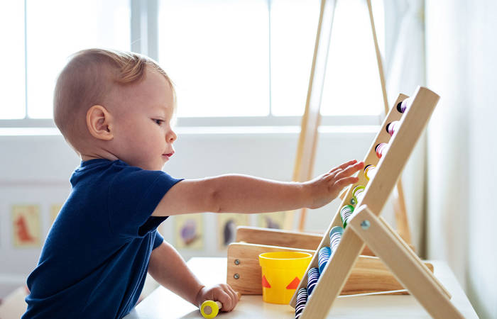 Little boy playing with an abacus