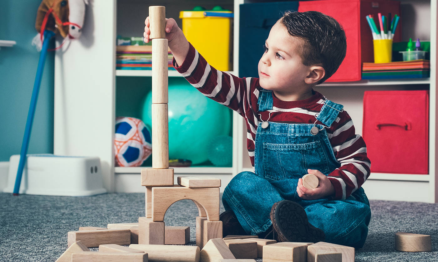 Boy building with wooden blocks