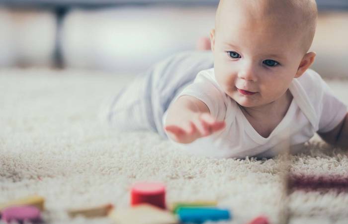 Baby on the floor with coloured blocks