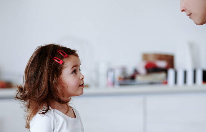 Profile view of girl listening to her mother