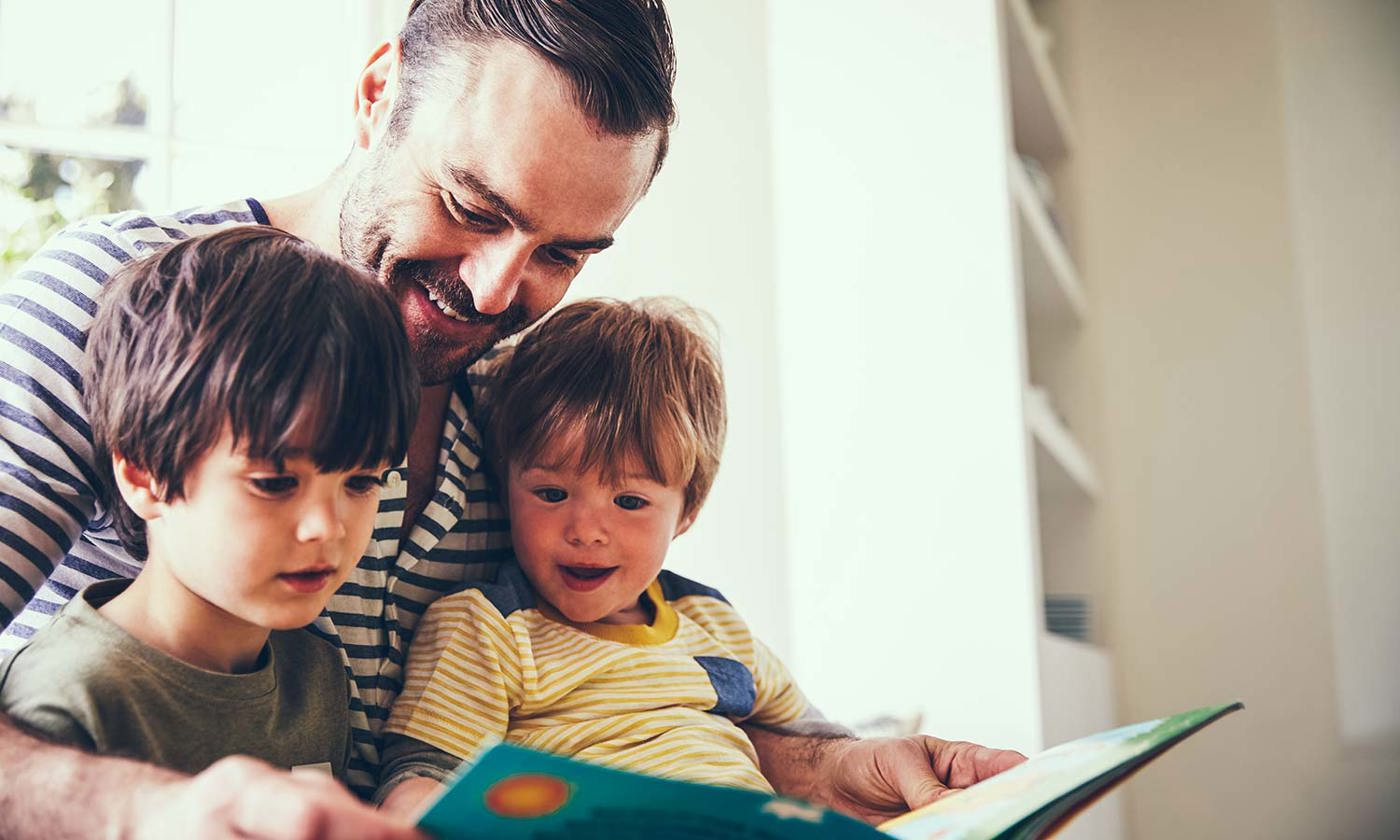 Father and sons reading
