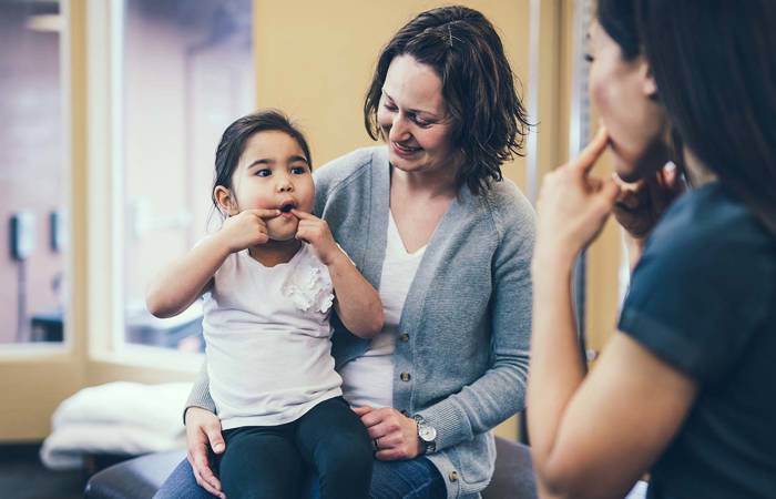 Speech therapist works with kindergarten aged girl