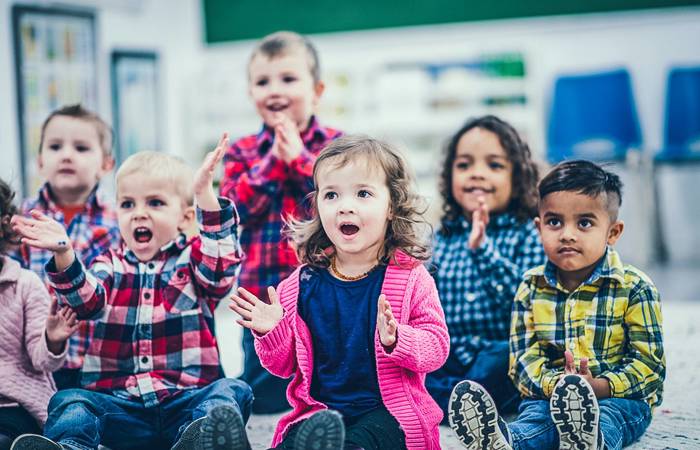 Children at an early learning centre clapping to a song