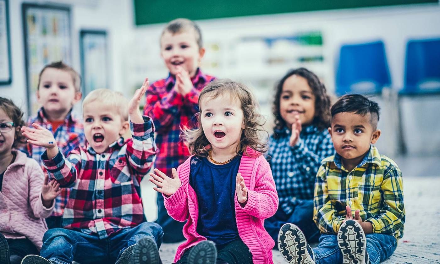 Children at an early learning centre clapping to a song