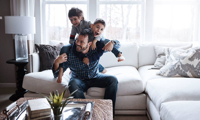 Little boys having fun with their father at home