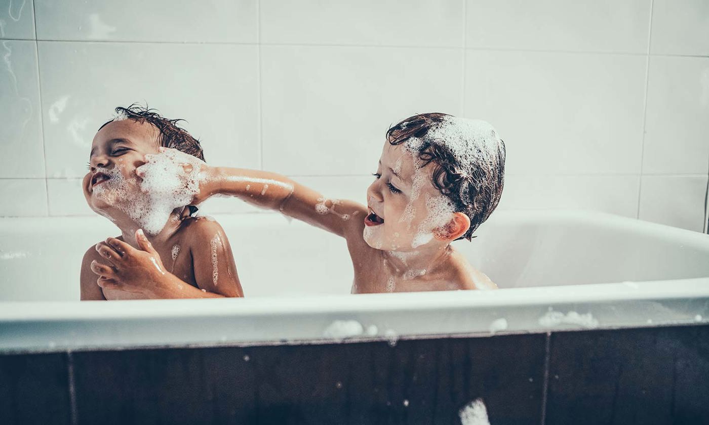Brothers playing in the bathtub