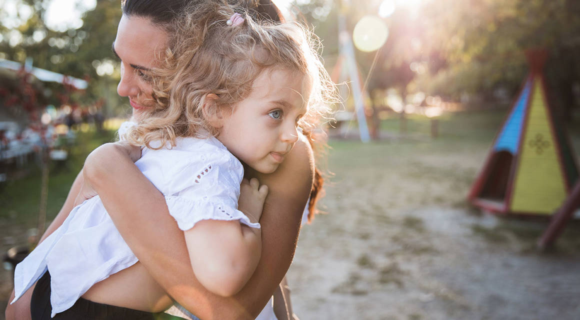 Woman hugging her frightened daughter