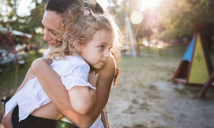 Woman hugging her frightened daughter