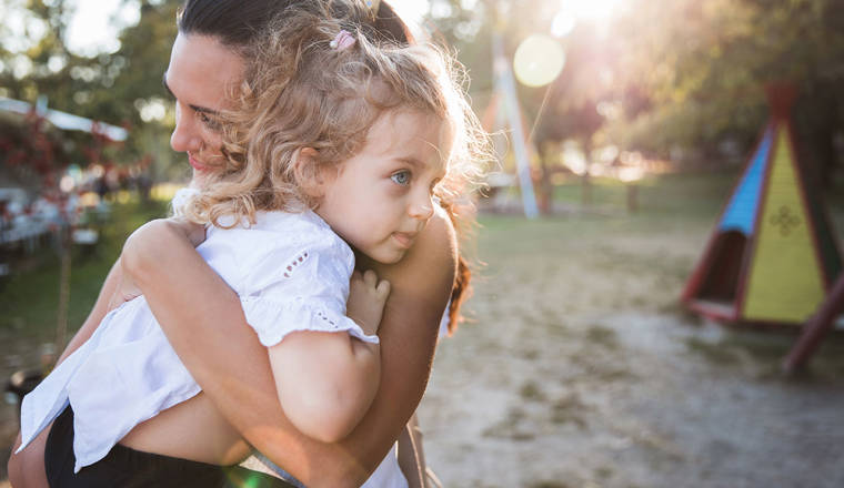 Woman hugging her frightened daughter