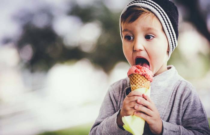 Young blond boy eating ice cream
