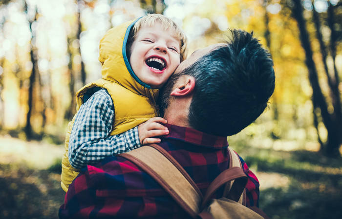 Father holding son in the outdoors