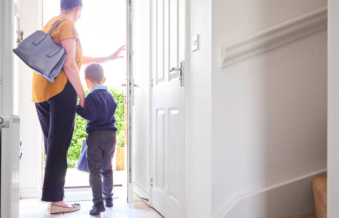 A mother and son on their way out for his first day at school