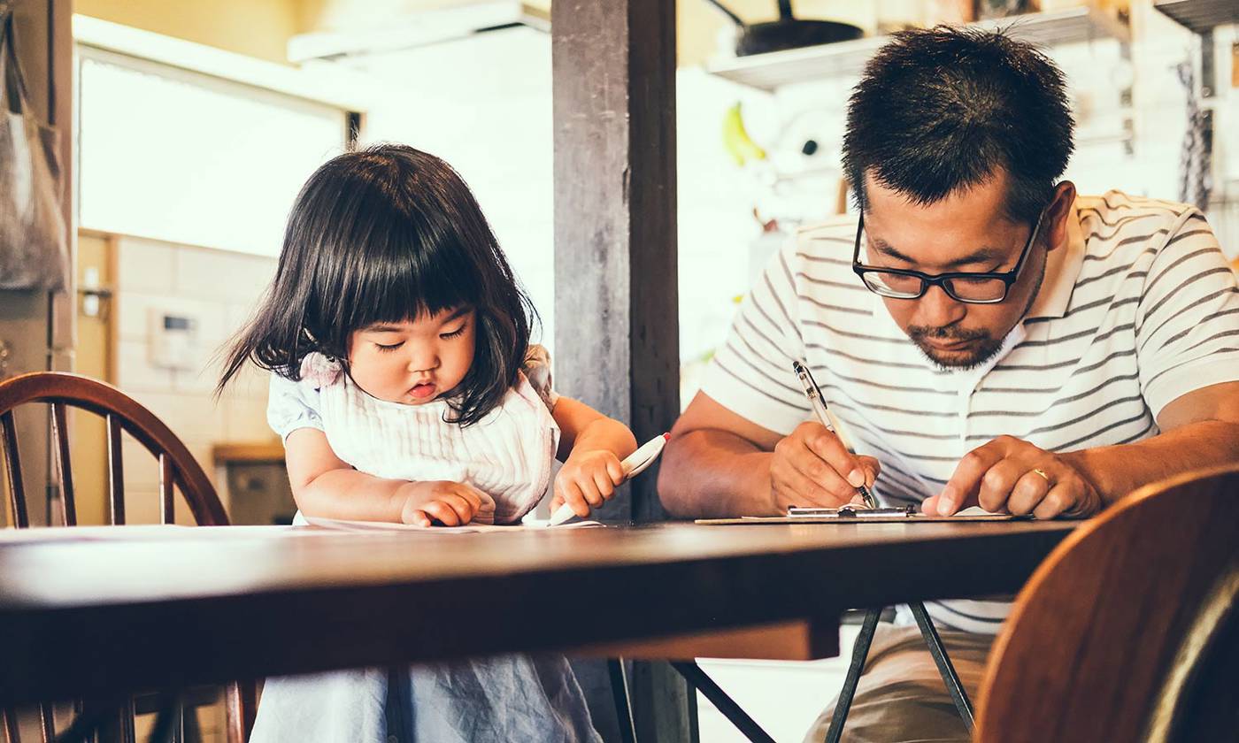 Father and daughter filling out paperwork