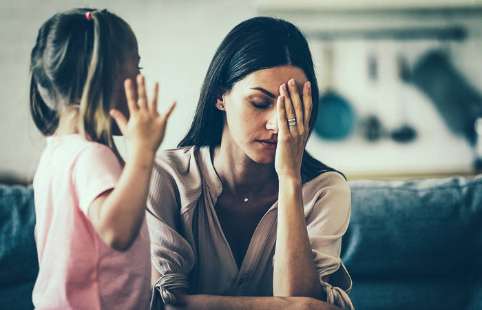 Tired mother with upset daughter