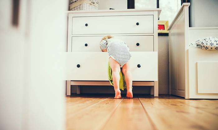 Toddler boy in a dangerous situation at home