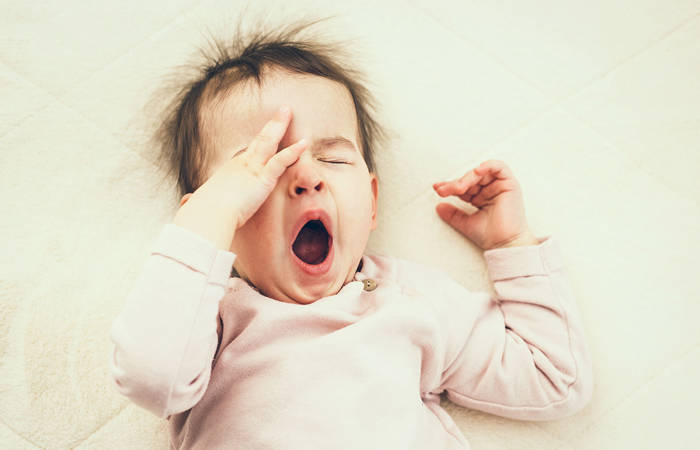 Sleepy baby yawning