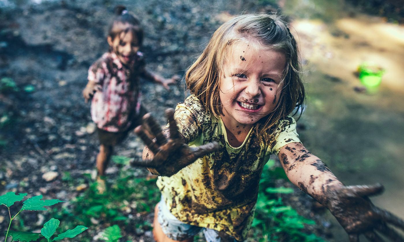 Smiling muddy little girl